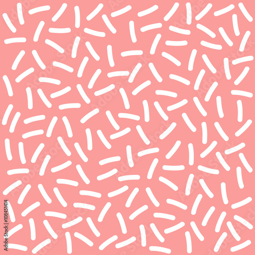 Seamless background with pink glaze and many white sprinkles.
