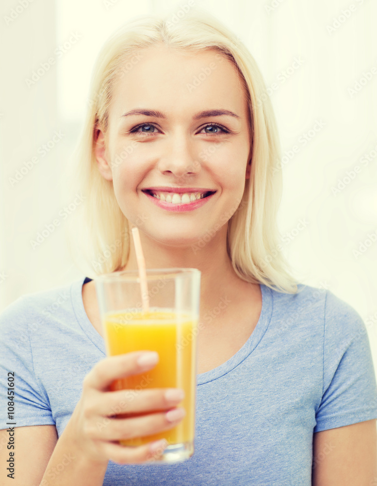 smiling woman drinking orange juice at home smiling woman drinking orange juice at home