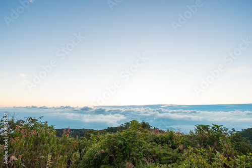 Sunrise on peak of mountain with fog white cloud