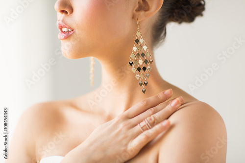 close up of beautiful woman with earrings