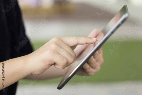 Woman Typing A Tablet