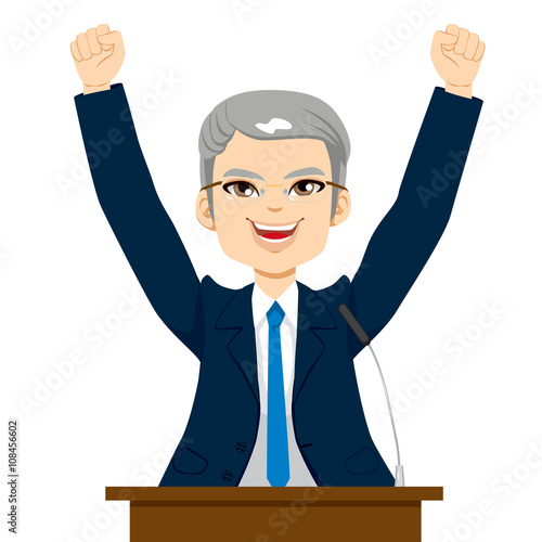 Happy senior politician man celebrating with fists up at podium