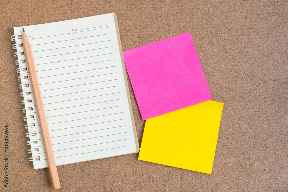 Fototapeta premium Open notebook with sticky notes on brown background