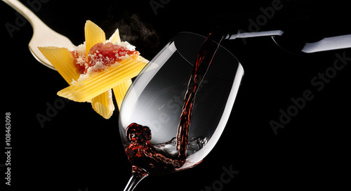 Macaroni with tomato sauce and glass with red wine