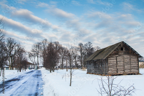 Wooden house in the snowy village © ozhukovaphoto