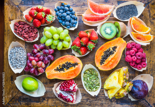 Fototapeta Naklejka Na Ścianę i Meble -  Fresh fruits background, berries, nuts, seeds top view.Healthy, detox, superfood.