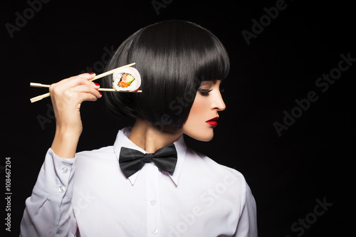 Young woman with wig holding sushi