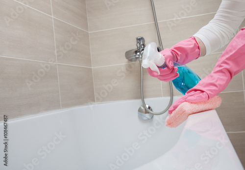 Housemaid cleaning a bathroom