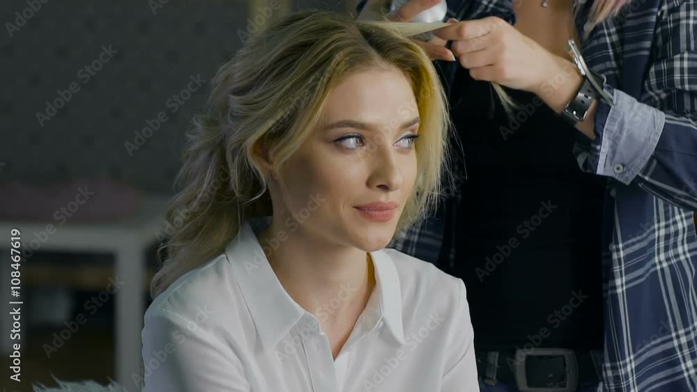 Blond female in hair salon. Hairdresser on background Blond female in hair salon. Hairdresser on background