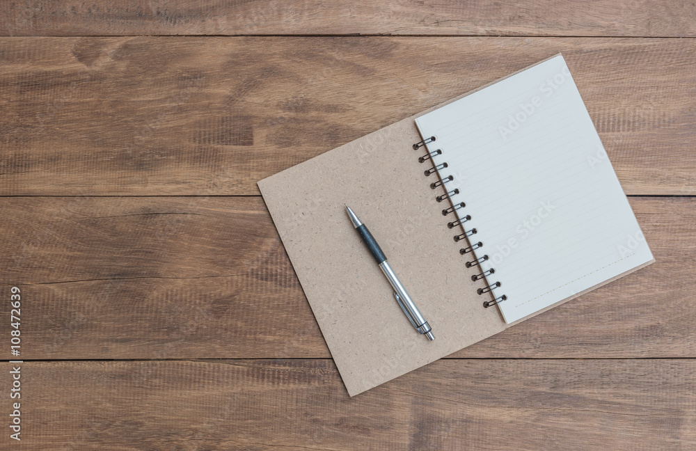 Open a blank notebook and pen on the table Open a blank notebook and pen on the table