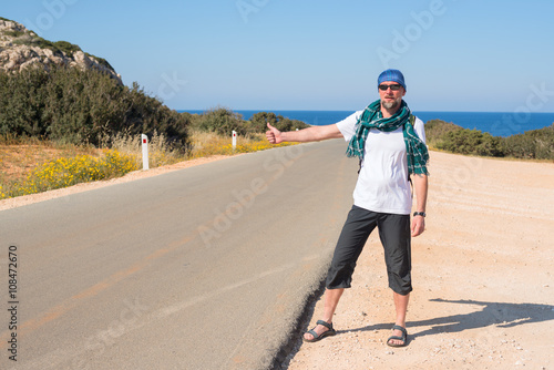 Man with backpack travels hitchhiking