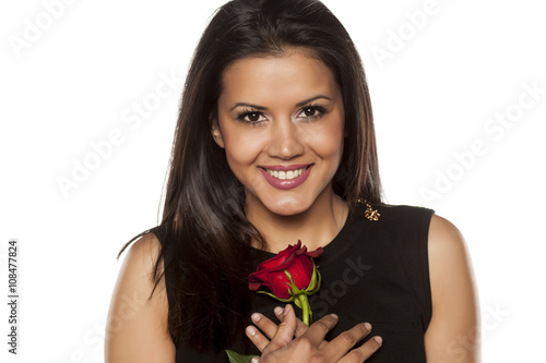 happy beautiful young woman holding a red rose © vladimirfloyd