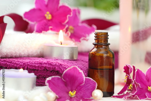 SPA setting with candles, aroma oil and violets