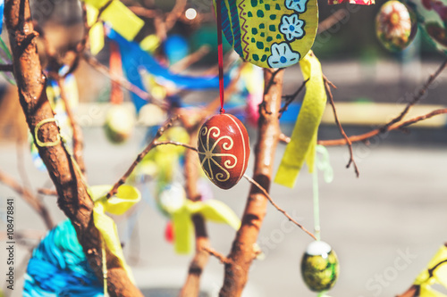 Group painted Easter eggs on tree branch