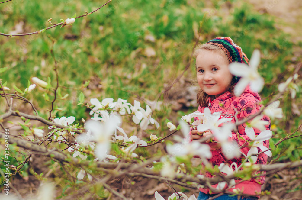 Little girl in garden, under the sakura tree. Little girl in garden, under the sakura tree.