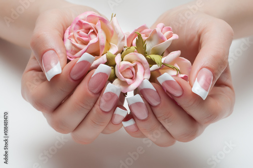 delicate French manicure with a rose in hand