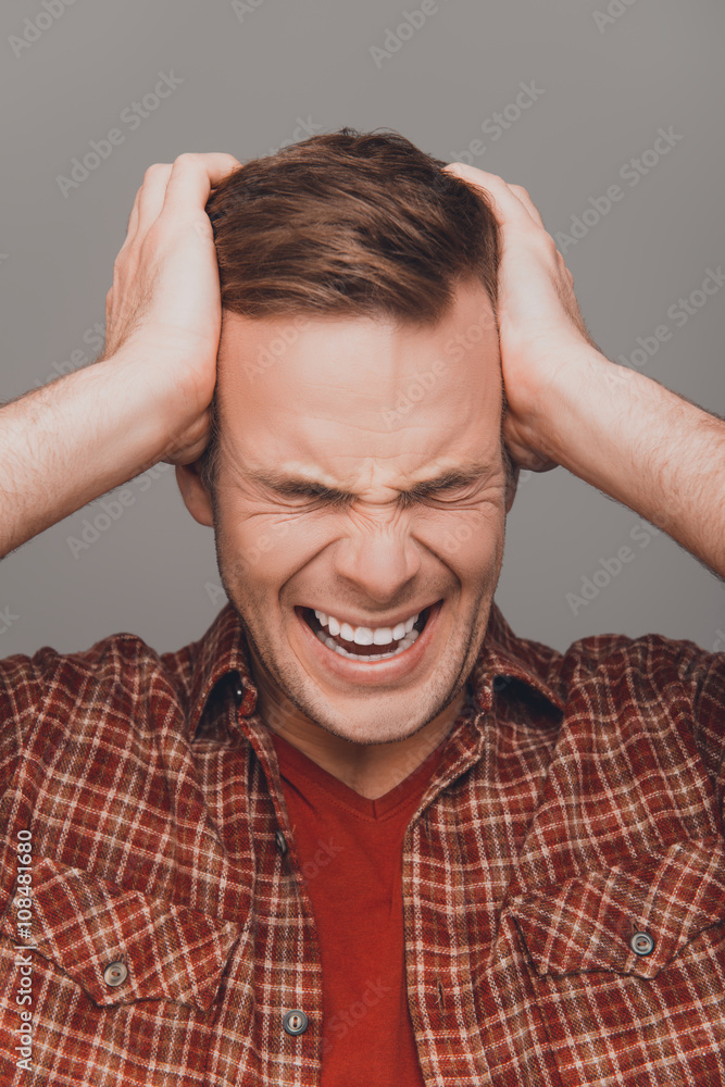 Close up portrait of young angry furios man toucing his head Close up portrait of young angry furios man toucing his head