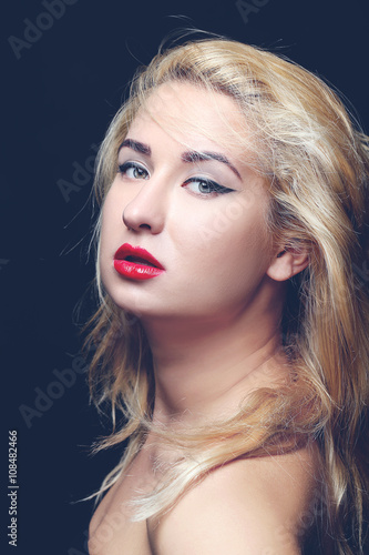 Portrait of beautiful model with make-up and red lips