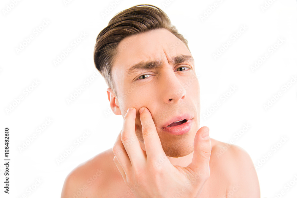 Close up photo of young attractive man expertising his face Close up photo of young attractive man expertising his face