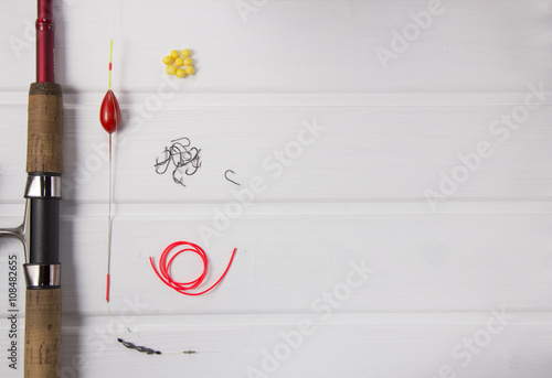 fishing gear on white wood background