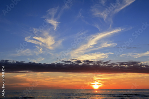 Fototapeta Naklejka Na Ścianę i Meble -  Threatening clouds over the festive sunset line.