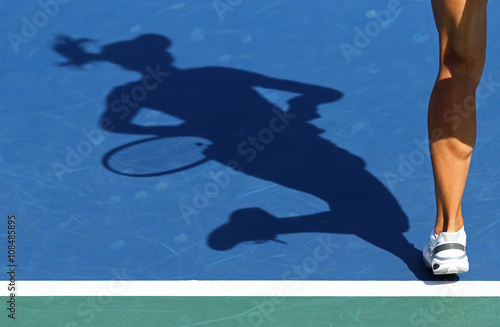 Shadow of woman tennis player photo