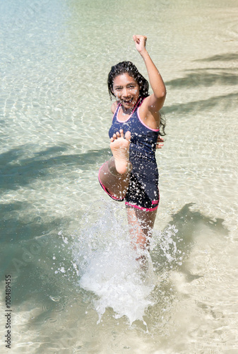 cheerful woman kicking her feet in the sea