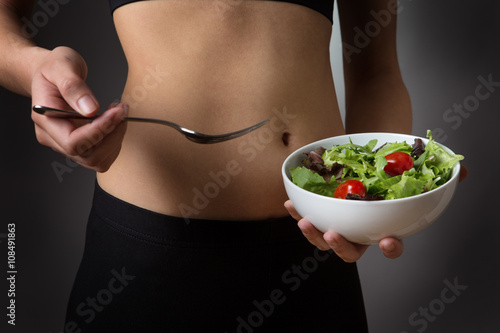 Photography holding a bowl of salad