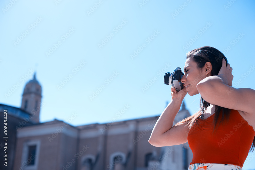 Young woman taking pictures in Rome