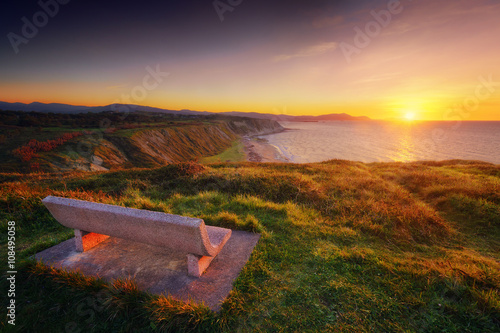 Bench at sunset with view of Azkorri beach in Getxo photo