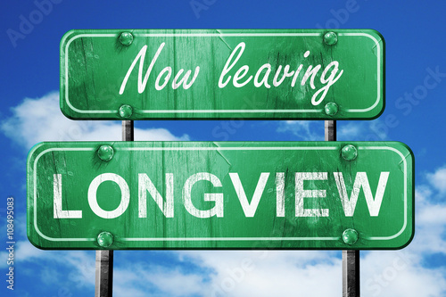 Leaving longview, green vintage road sign with rough lettering photo