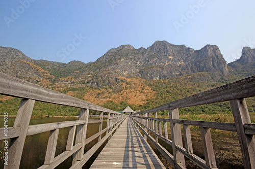 long wooden jetty on nature lake