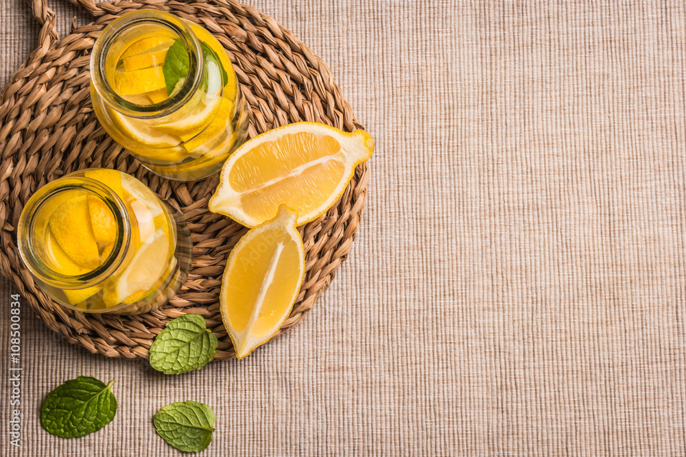Slices and half fresh juicy lemon with mint leaves Slices and half fresh juicy lemon with mint leaves
