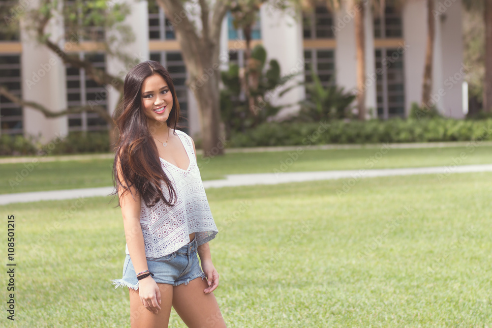 Portrait of a casual smiling young pretty Asian girl outdoors - Portrait of a casual smiling young pretty Asian girl outdoors -