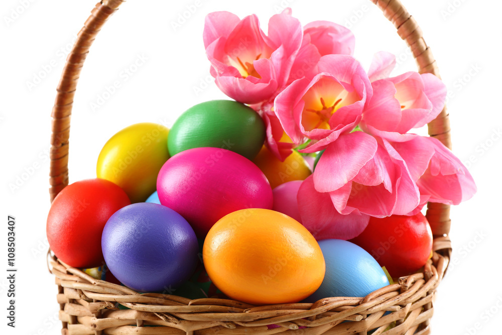 Naklejka premium Multicoloured Easter eggs in basket isolated on white
