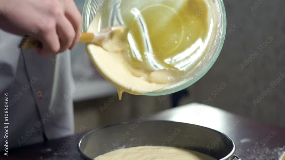 Man extracting liquid cake batter from mixing bowl. Baking cake. Home baking. Baking ingredient. Baking apple pie Man extracting liquid cake batter from mixing bowl. Baking cake. Home baking. Baking ingredient. Baking apple pie