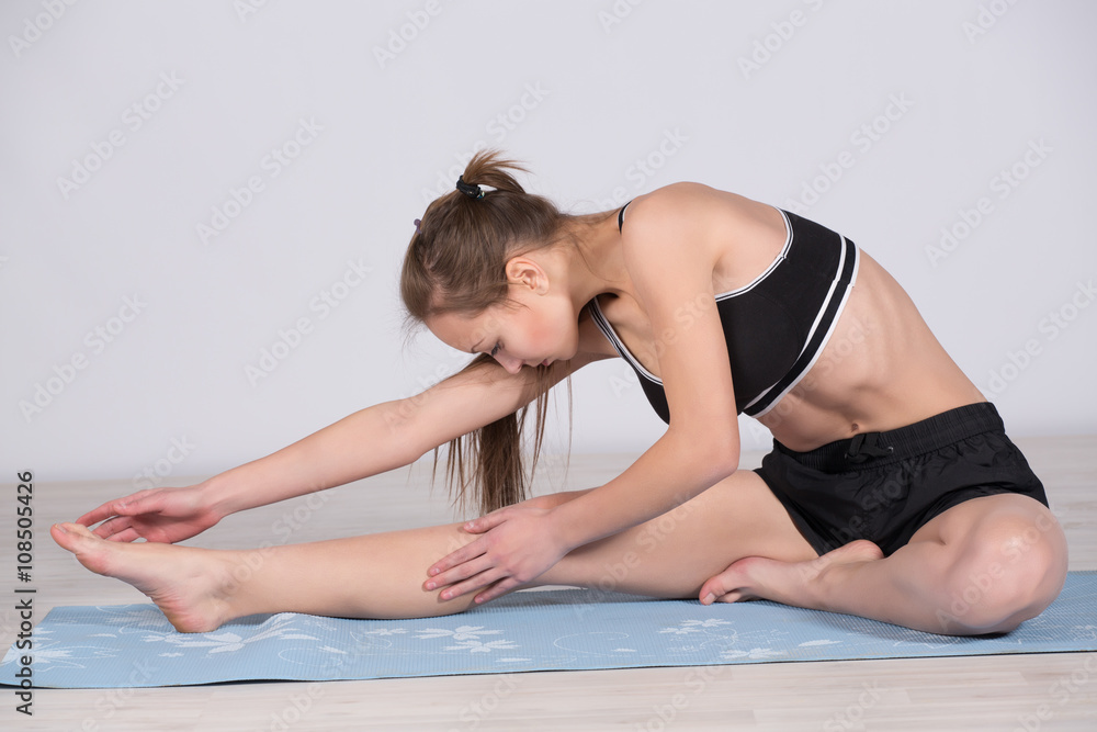 young girl engaged in yoga exercising and stretching young girl engaged in yoga exercising and stretching