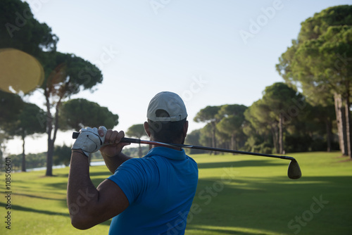 golf player hitting shot