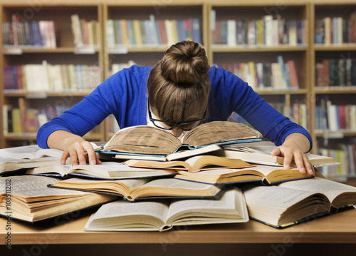 Student Studying Hard Exam, Sleeping on Books Read in Library photo