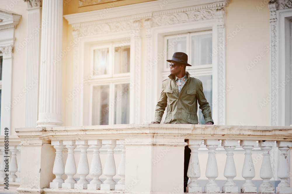 Fashion portrait of black african american man on green coat clo Fashion portrait of black african american man on green coat clo