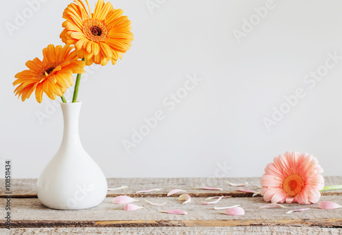 Gerbera in vase on old wooden table