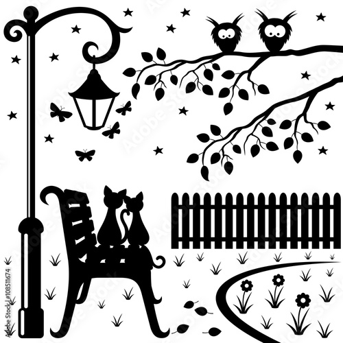 Two cats sitting on a park bench.