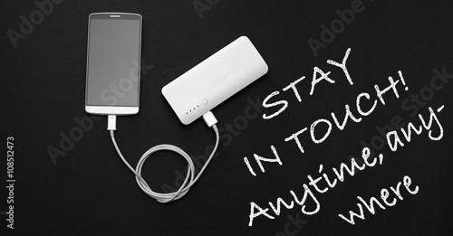 Powerbank and smartphone on dark background