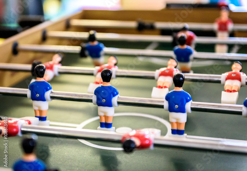 Close up of foosball Table Soccer Game match figures. © _jure