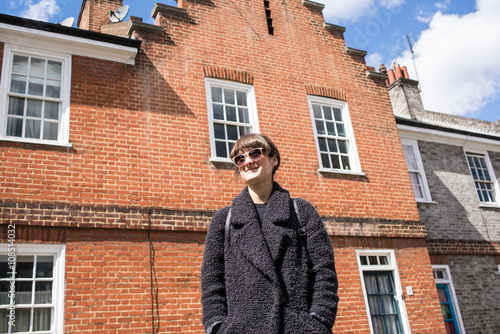 Hipster woman wearing sunglasses and wool black jacket  photo