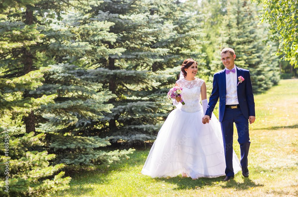 Bride and groom on their wedding day outdoors Bride and groom on their wedding day outdoors