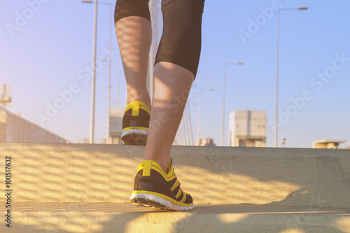 Urban jogger on a staircase of the bridge.