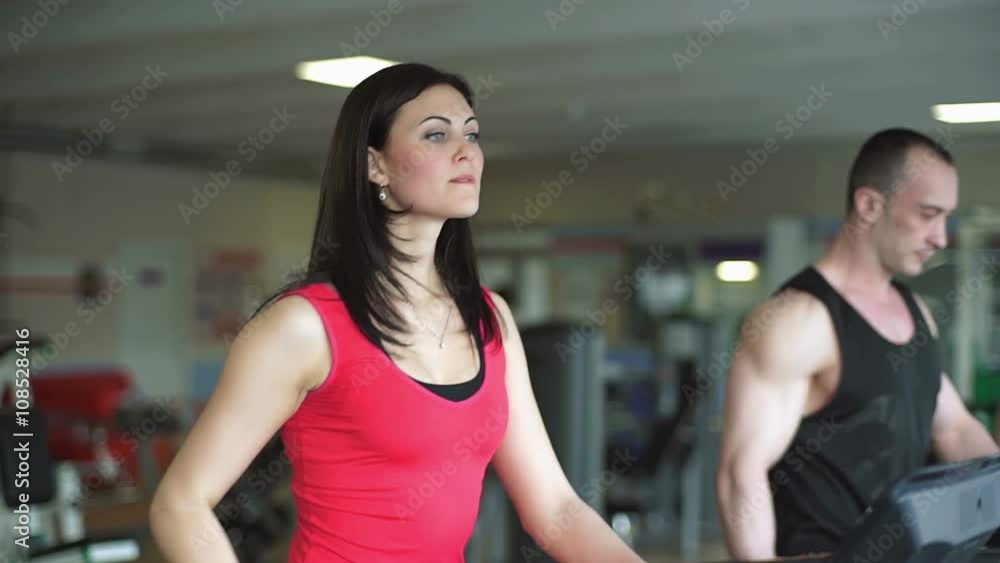 The girl in the gym drinking water from a bottle The girl in the gym drinking water from a bottle
