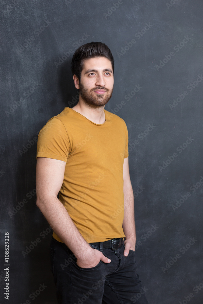 Handsome young man smiling on black background. Studio shot.