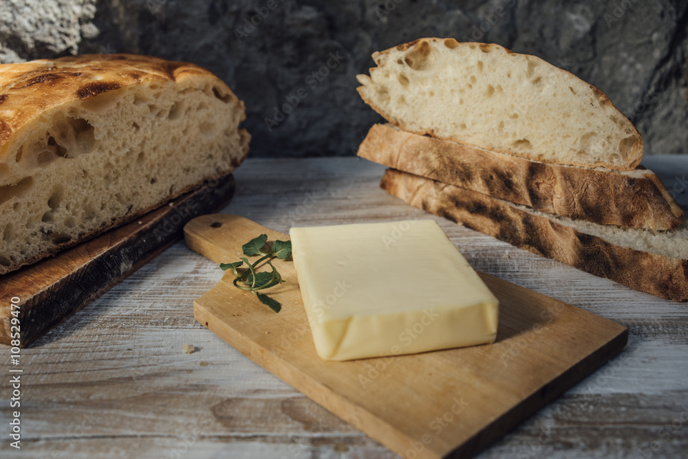 Pieces of rustic round loaf bread with butter